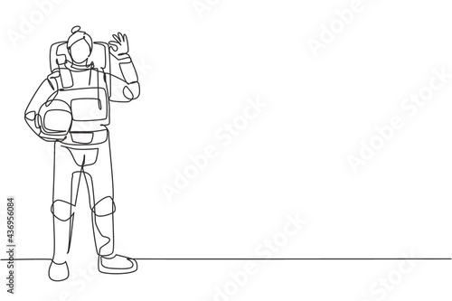 Single continuous line drawing female astronaut stands with gesture okay wearing space suit exploring earth, moon, other planets in universe. Dynamic one line draw graphic design vector illustration