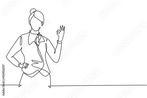 Single one line drawing flight attendant with gesture okay ready to serve airplane passengers in a friendly and warm manner. Professional work. Continuous line draw design graphic vector illustration