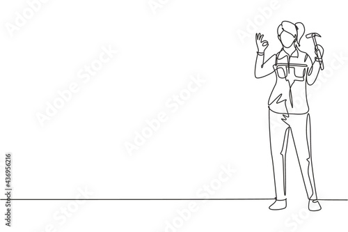 Single one line drawing female carpenter standing with gesture okay works for wood industry and must be skilled at using carpentry tools. Modern continuous line draw design graphic vector illustration