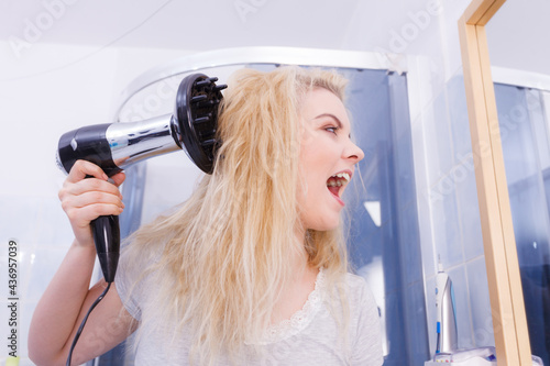 Woman doing curls with hairdryer diffuser