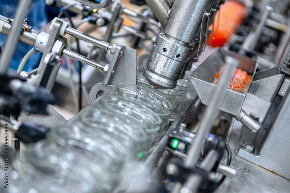 Machine for filling red caviar into glass jars. Filling equipment, food industry Machine for filling red caviar into glass jars. Filling equipment, food industry