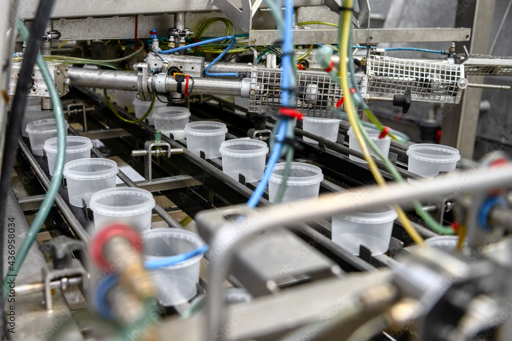 Seaweed salad on a conveyor belt. Automatic line for packing seafood Seaweed salad on a conveyor belt. Automatic line for packing seafood