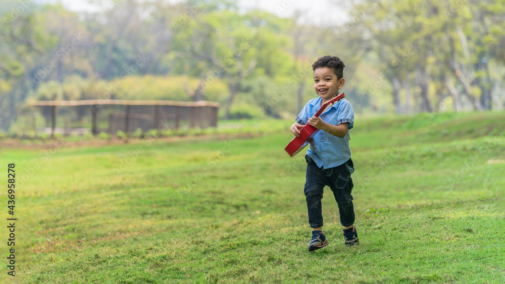 Fototapeta premium mixed race caucasian and asian boy having fun playing in park