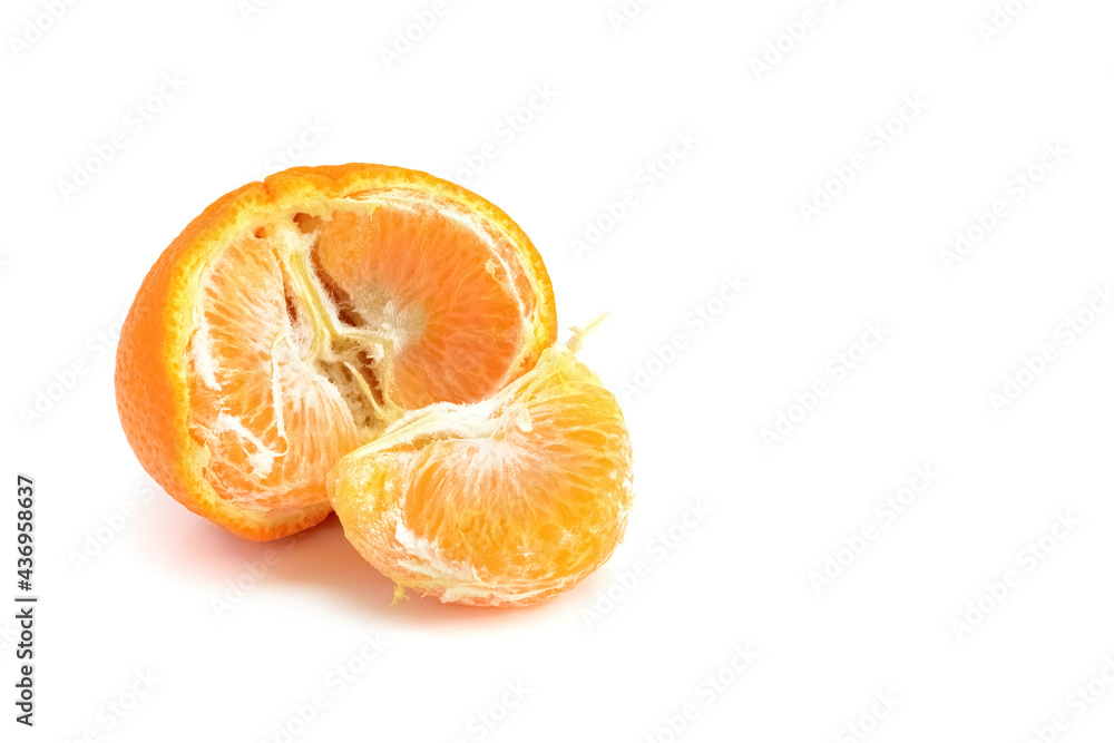 Half a tangerine and slices isolated on a white background.
