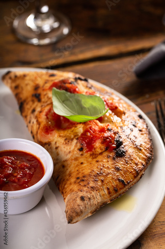 Fotografija Traditional Italian cheese calzone with marinara sauce