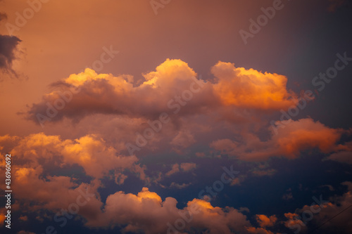 beautiful clouds are painted by the setting sun in bright fiery colors