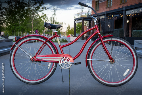 Calgary Alberta Canada, May 30 2021: A ladies Huffy cruiser bicycle parked on a pathway at East Village downtown during a summer evening.