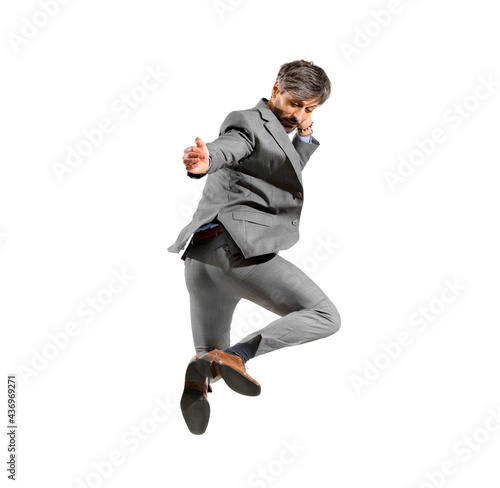 Athletic businessman in smart suit leaping in the air