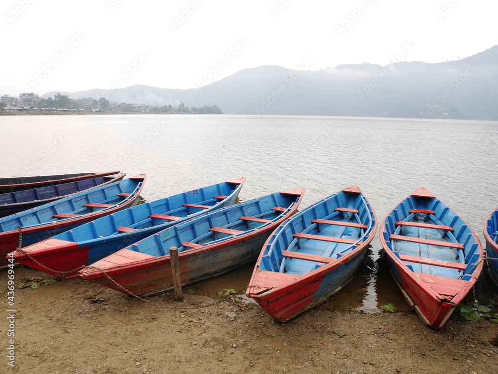 Wooden canoe boat of nepali people floating in Phewa Tal or Fewa