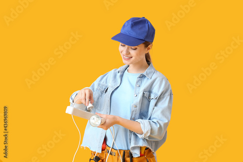 Young female electrician pl...