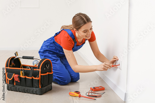 Young female electrician re...