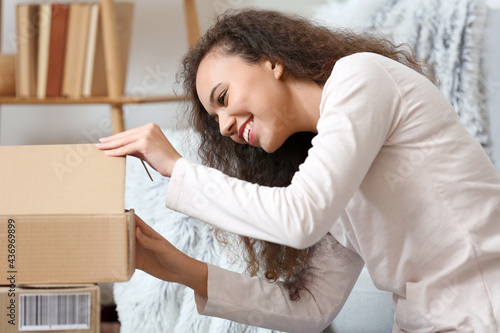 Happy young woman unpacking...