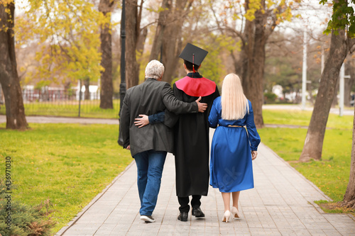 Young man with his parents on graduation day photo