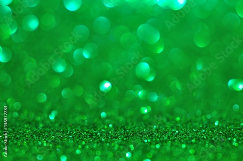 Background abstract green bokeh lights glittering on blur background 