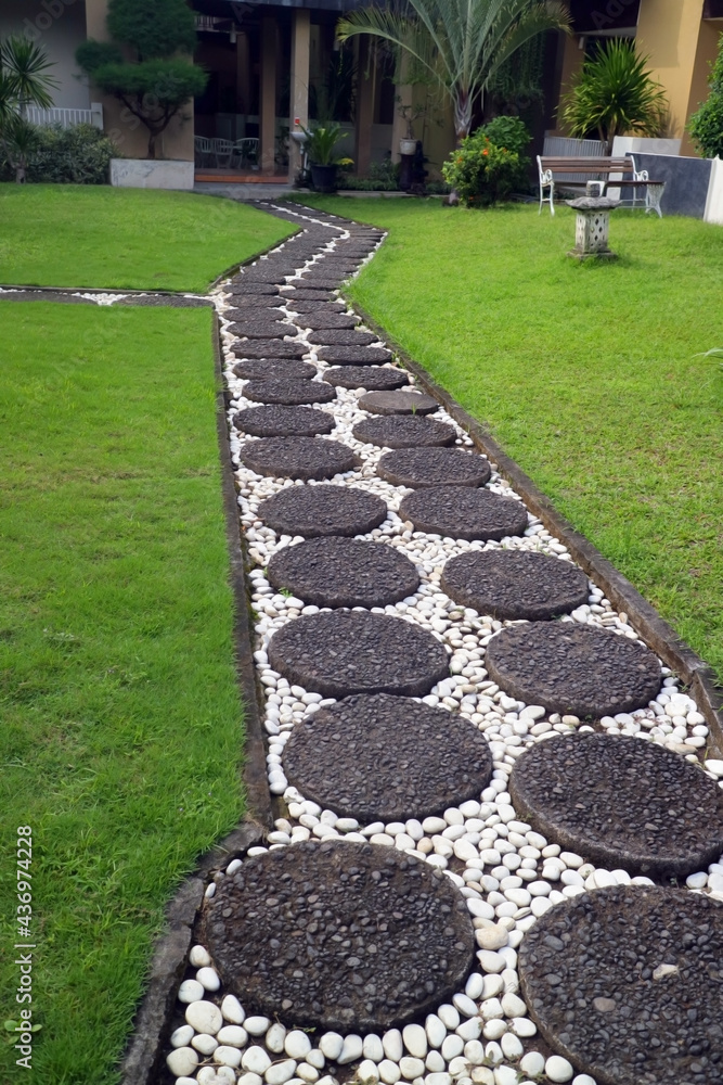 cobblestone path in the grass in the hotel garden cobblestone path in the grass in the hotel garden