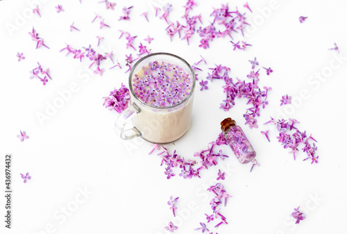 Cup of coffee with lilac petals. Morning inspiration
