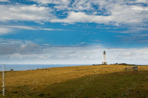 Typical white lighthouse in a landscape in the north of Spain, in Lastres Asturias, © OMP.stock