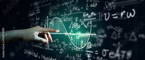 Obraz na plátně Hand on science formula and math equation abstract black board background