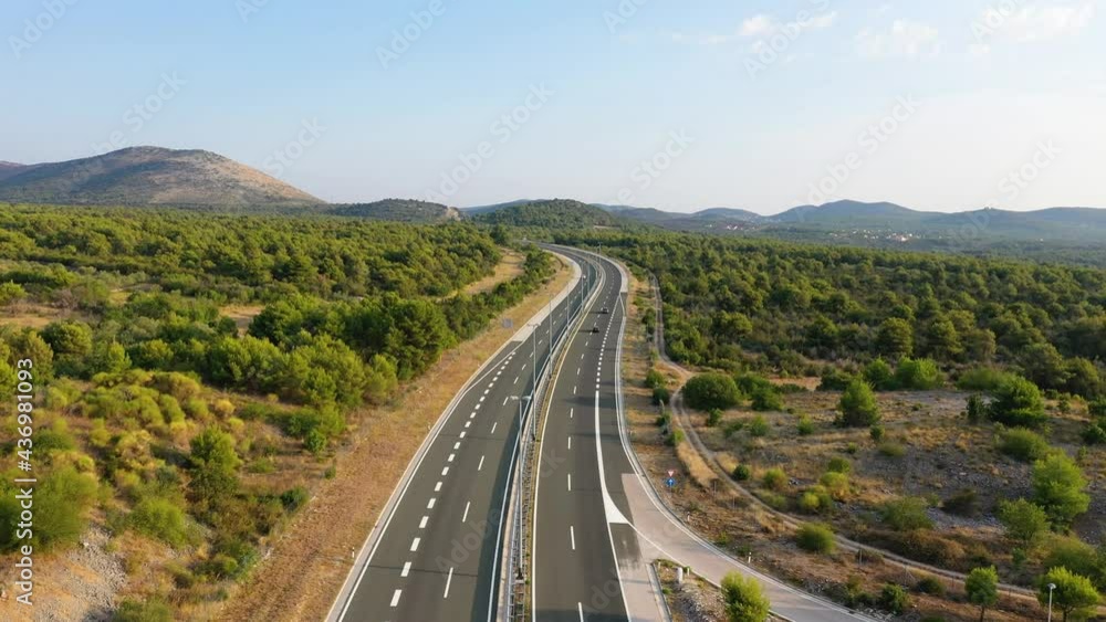 Aerial view on road. Highway through mountain valley. View from a drone. Natural landscape in summer time from air. Travel and vacation. Transportation video Aerial view on road. Highway through mountain valley. View from a drone. Natural landscape in summer time from air. Travel and vacation. Transportation video