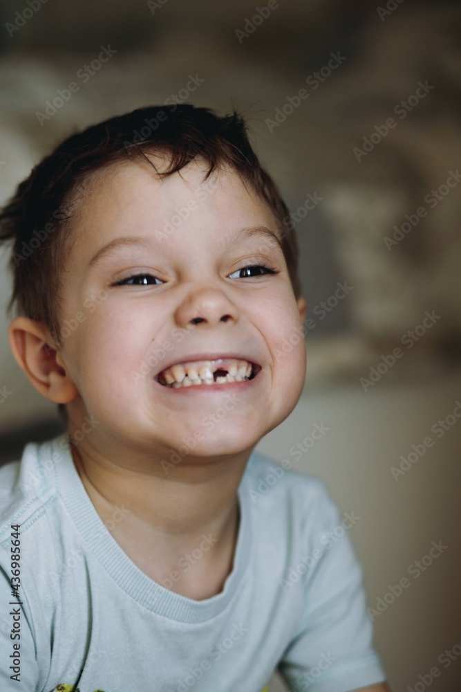 close up portrait of cute caucasian 6 year old boy with lost front tooth. Image with noise effect close up portrait of cute caucasian 6 year old boy with lost front tooth. Image with noise effect