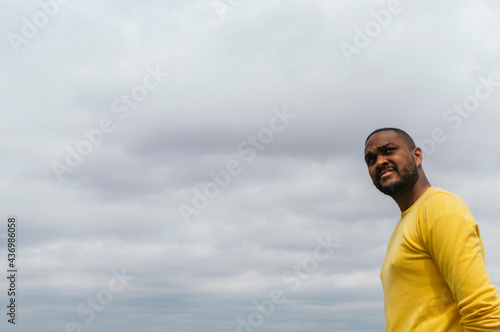 Black man looking at the horizon in a park
