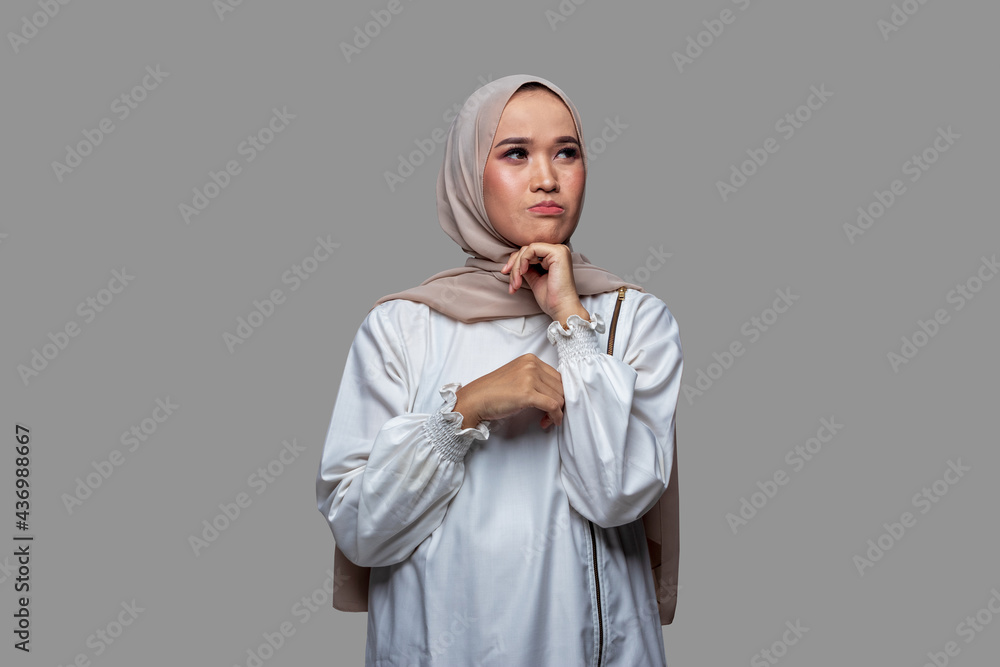 Indonesian woman in hijab with sad, worried and disappointed expression