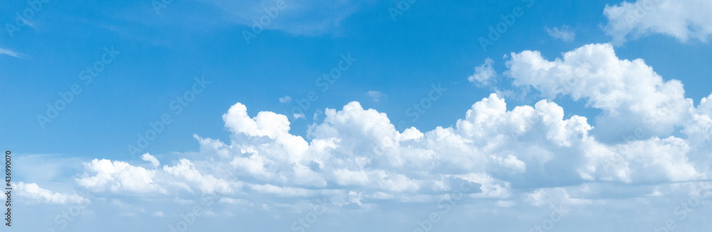 Panoramic photo of a blue sky with cumulus clouds.