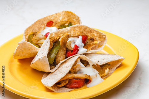 wholewheat pitta bread filled with grilled chicken meat, jalapenos and red pepper