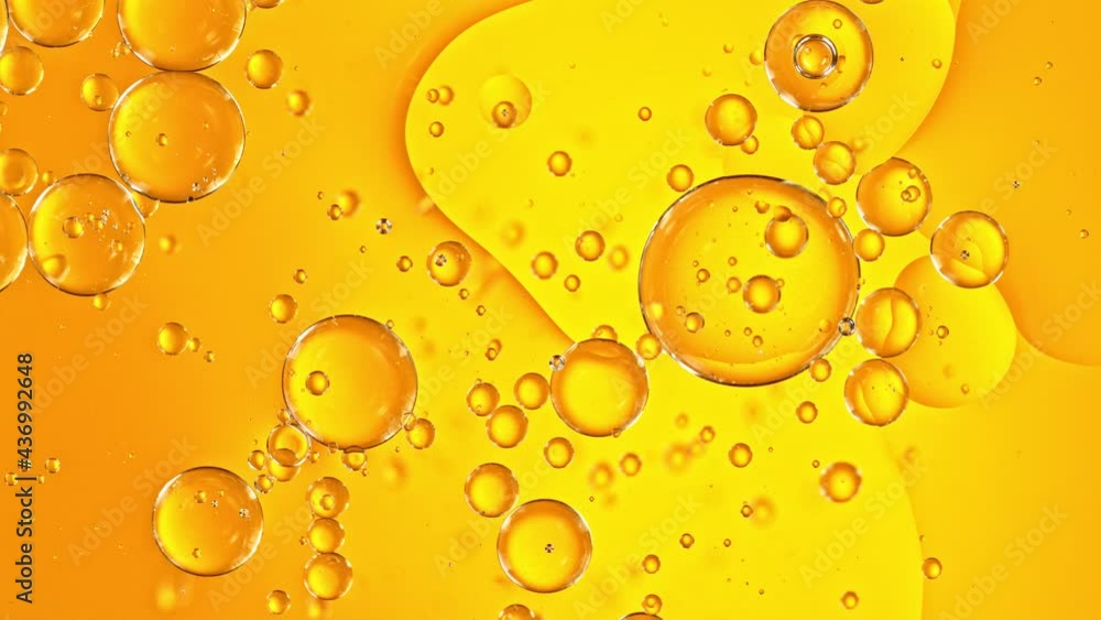Super Slow Motion Shot of Moving Oil Bubbles on Golden Background at 1000fps. Super Slow Motion Shot of Moving Oil Bubbles on Golden Background at 1000fps.