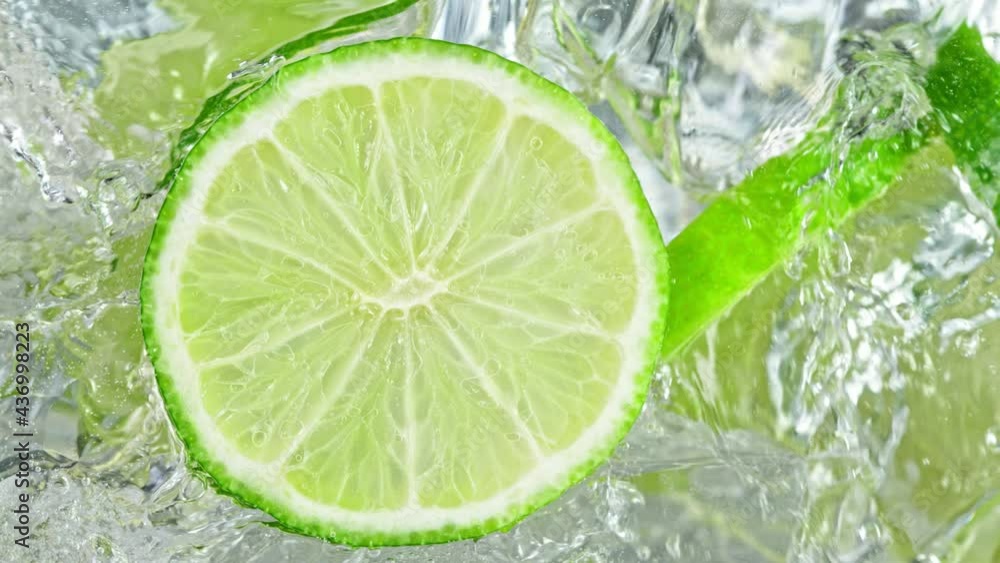 Super Slow Motion Shot of Pouring Lemonade into Glass With Lime Slices and Ice Cubes at 1000 fps. Super Slow Motion Shot of Pouring Lemonade into Glass With Lime Slices and Ice Cubes at 1000 fps.