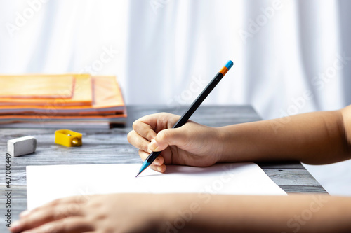 Child writing with pencil