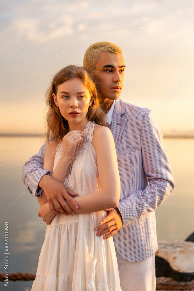 young couple in the seaport on the background of the sea