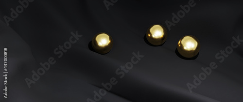 3d render of gold ball and black cloth. iridescent holographic foil. abstract art fashion background.