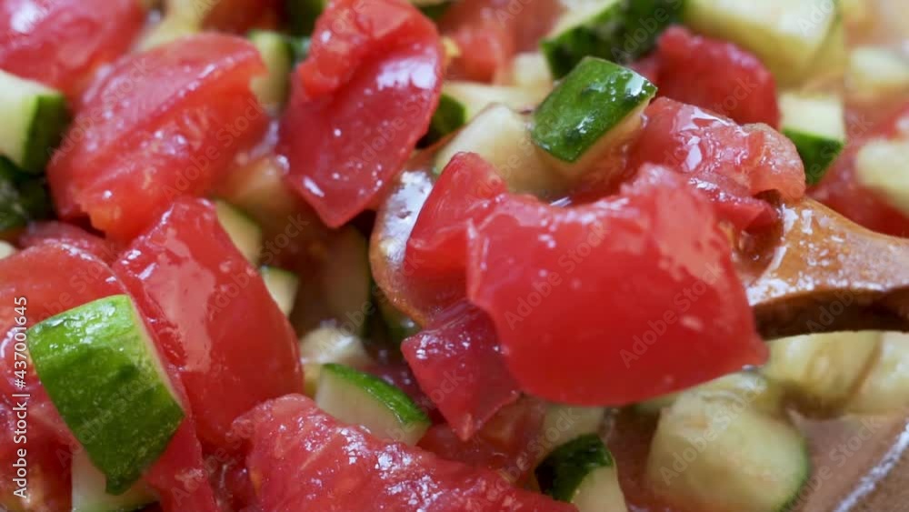 Eating a Salad of Fresh Chopped Vegetables Tomatoes and Cucumbers with Olive Oil, Macro. The Concept of a Healthy Vegetarian Diet and Vegan Food. Eating a Salad of Fresh Chopped Vegetables Tomatoes and Cucumbers with Olive Oil, Macro. The Concept of a Healthy Vegetarian Diet and Vegan Food.