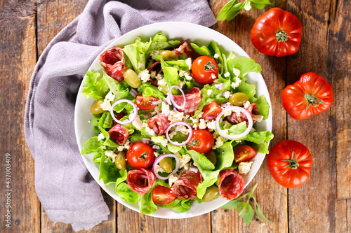 vegetable salad with salami,  tomato and cheese
