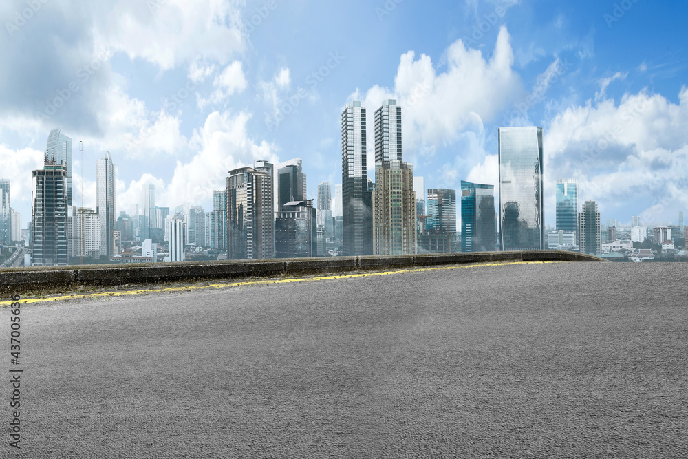 Asphalt road with modern building and skyscrapers Asphalt road with modern building and skyscrapers