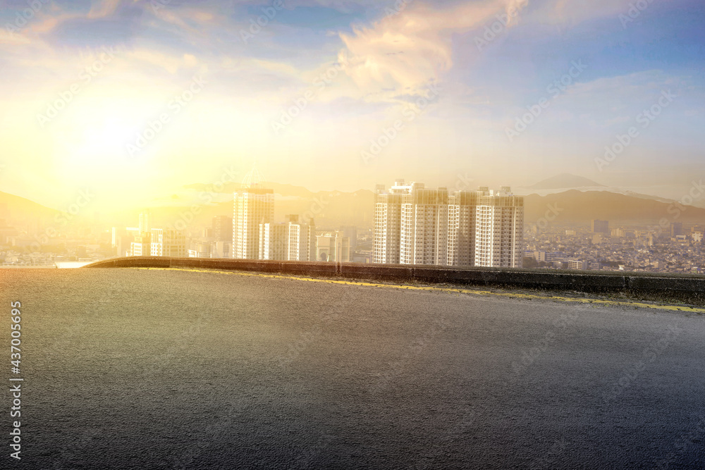 Naklejka premium Asphalt road with modern building and skyscrapers