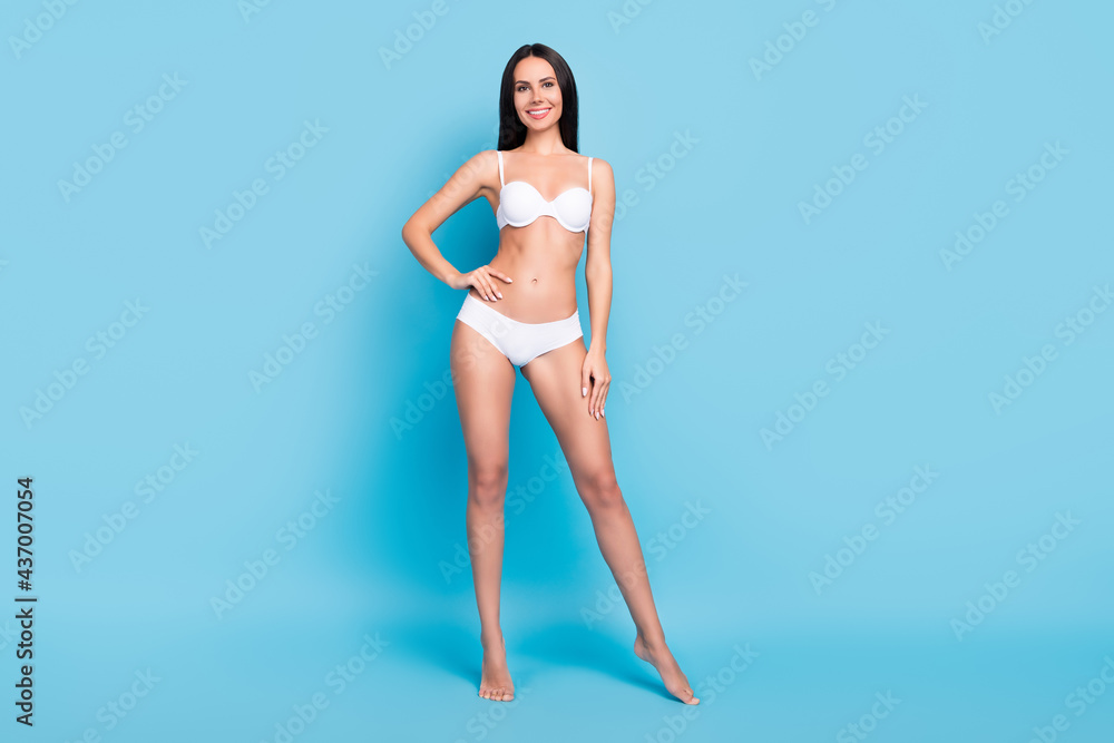Full body photo of optimistic brown hairdo lady show perfect shape wear white undercloth isolated on blue background Full body photo of optimistic brown hairdo lady show perfect shape wear white undercloth isolated on blue background