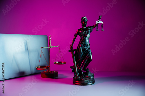 Bronze statue Lady Justice holding scales and sword in notary office