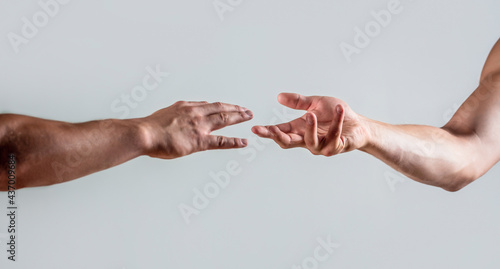Two hands, helping arm of a friend, teamwork. Rescue, helping gesture or hands. Close up help hand. Helping hand concept, support. Friendly handshake. Two hands, shaking hands