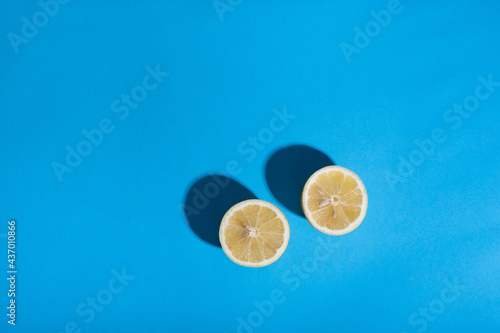 two slices of lemon on a blue background. stock photo