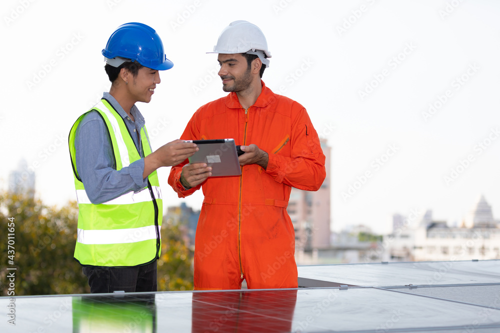 engineers or technicians holding tablet, talking about project with solar panels engineers or technicians holding tablet, talking about project with solar panels