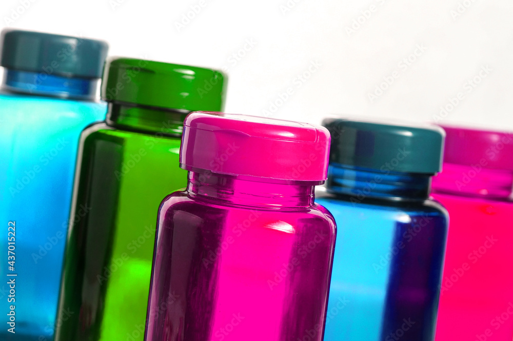 colorful bottles with pills over white background colorful bottles with pills over white background