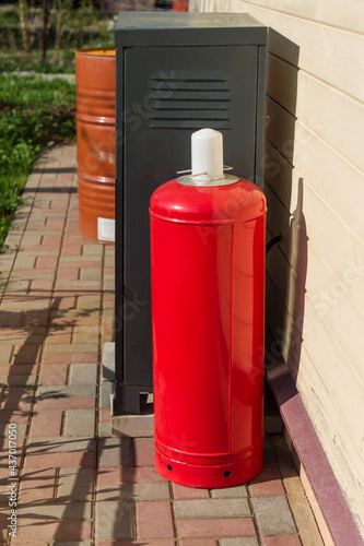compressed gas, argon or carbon dioxide or oxygen,a steel cylinder outdoors.