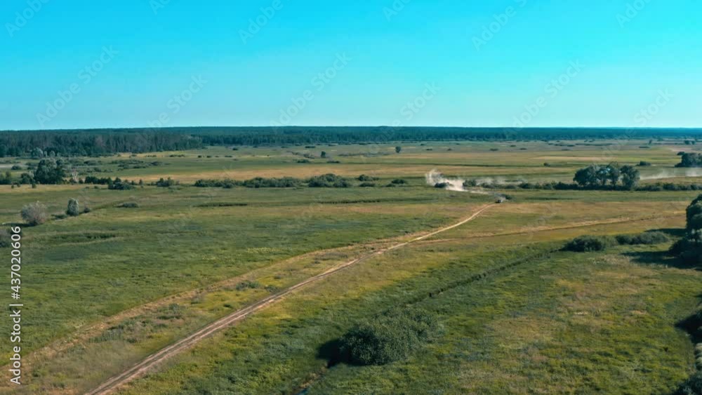 Aerial cinematic view from drone which is pursuit a buggy car going in cross country road. Fast buggy is going with big clouds of dust. Top view from drone onto car race. Aerial cinematic view from drone which is pursuit a buggy car going in cross country road. Fast buggy is going with big clouds of dust. Top view from drone onto car race.