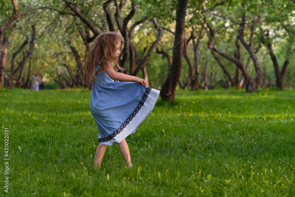 little girl runs barefoot on the grass. happy child on a hot summer day. little girl runs barefoot on the grass. happy child on a hot summer day.