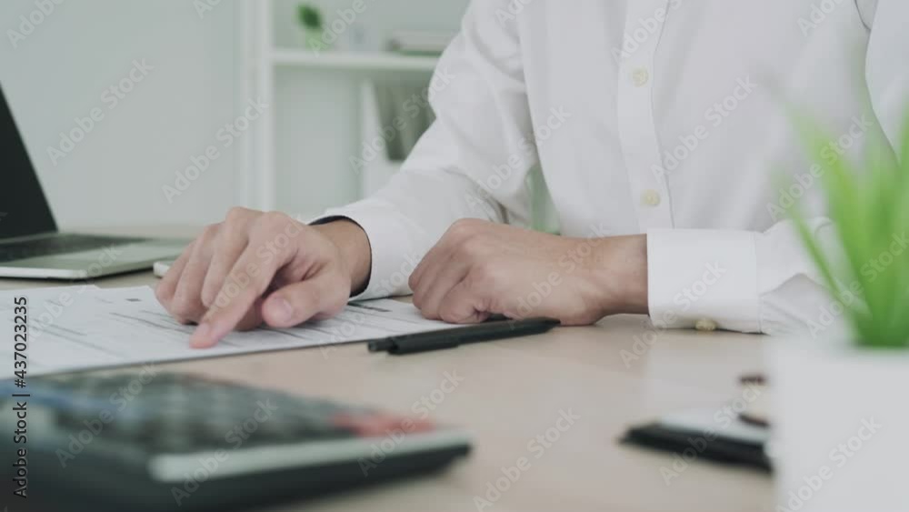 Business man using a mobile phone scan barcode and QR code. Business man recheck bill and statement for pay by staying on office. Concept scan for pay by mobile phone.