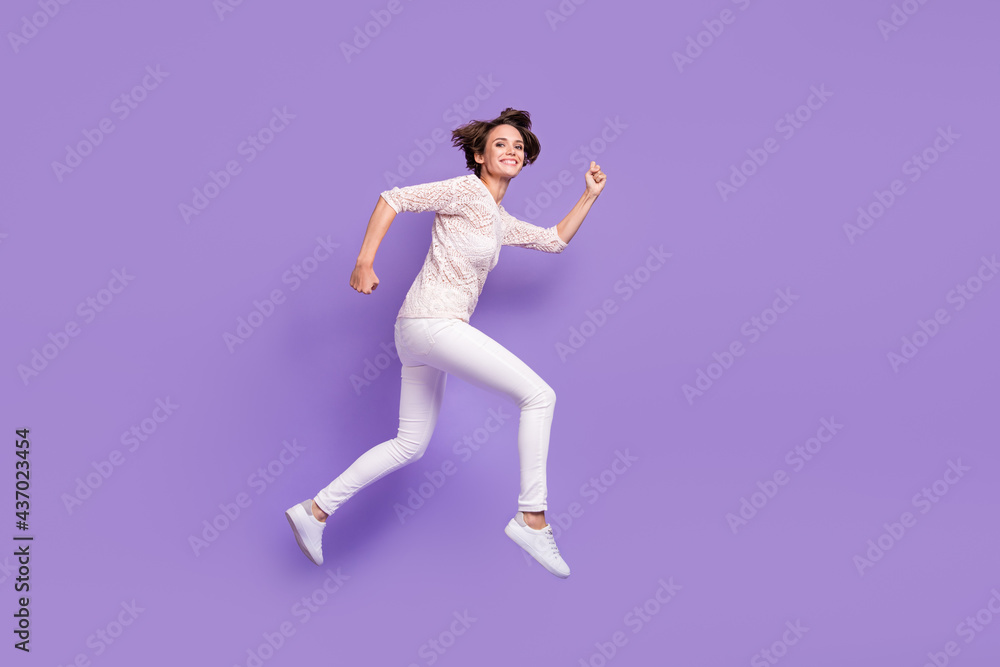 Full body profile portrait of cheerful charming girl running look camera isolated on purple color background