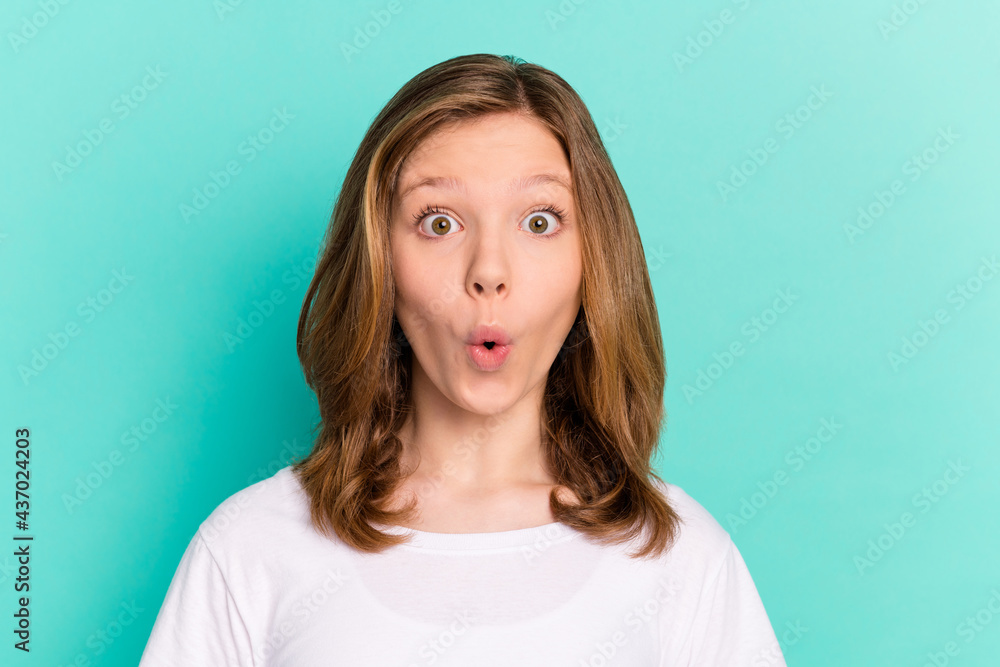 Photo portrait little girl amazed staring with opened mouth isolated vivid teal color background Photo portrait little girl amazed staring with opened mouth isolated vivid teal color background