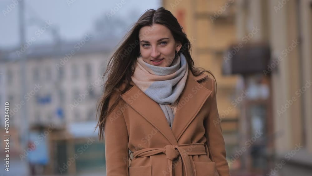 Portrait of a posing happy girl in the city in early spring. Portrait of a posing happy girl in the city in early spring.